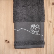 Gray “Mountain” washcloth embroidered with a white sheep design.