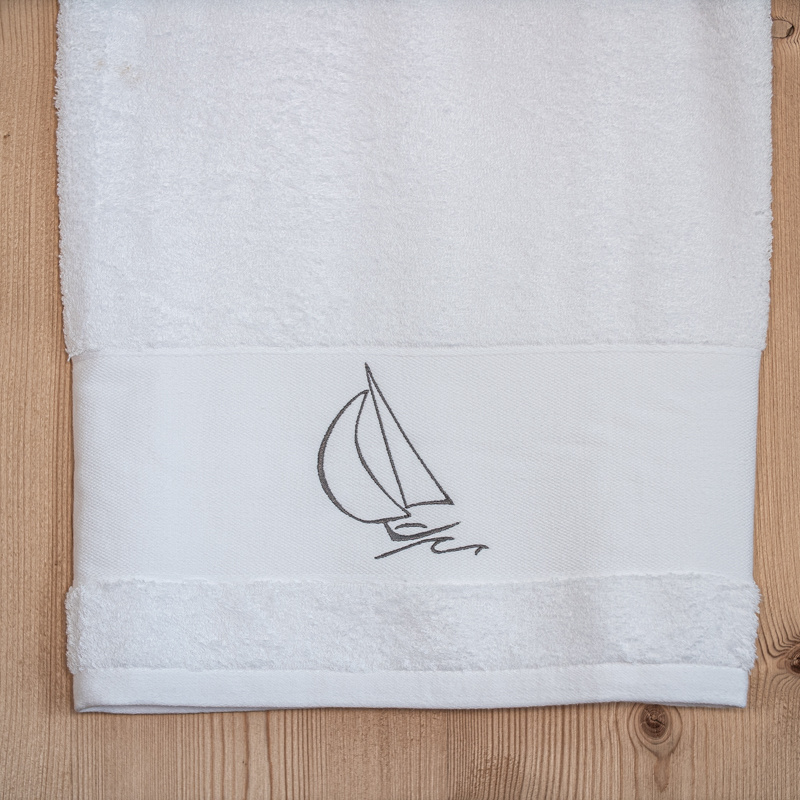 White shower towel with a sailboat 28 x 55 in