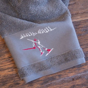 Grey guest towel with skier...
