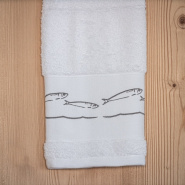 Serviette de toilette bord de mer brodée de motifs sardines grises.