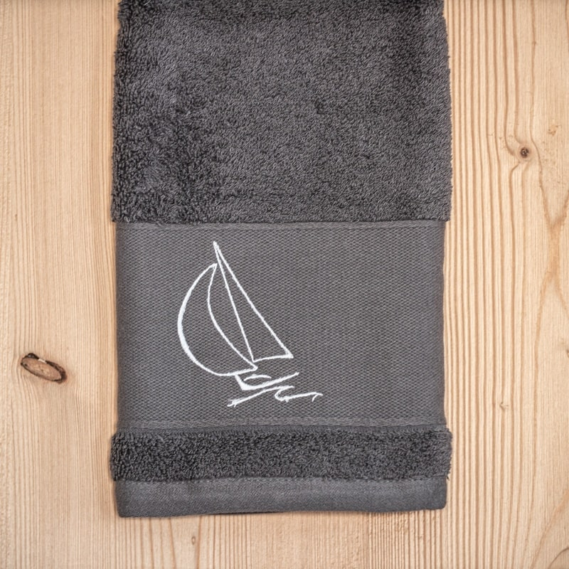 Grey bath towel with a sailboat 20 x 40 in