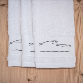 White guest towel with fish...