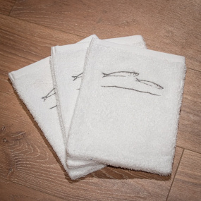 White washcloths with fish...