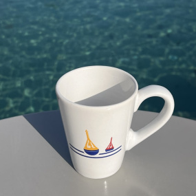 Seaside mug with a beacon motif.