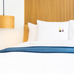 Photo of beacon-pattern pillowcases arranged on a bed.
