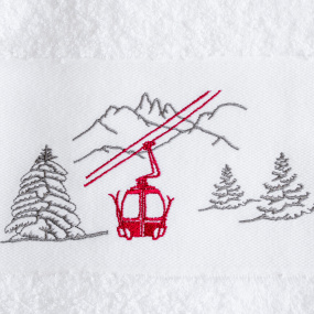 Dettaglio del ricamo del motivo funivia rossa sul telo doccia stile montagna.