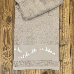 Toalla de baño de estilo rústico, de color beige, bordada con un motivo de bosque de abetos blancos.