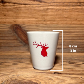 Mountain-style coffee cup with a red deer pattern and measurement markings.