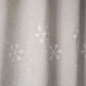Close-up of the detailed snowflake motif embroidery.