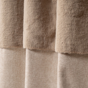 Close-up of the beige curtain's fur trim and fabric texture.