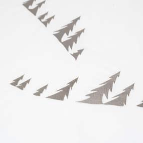 Close-up of the grey pine tree embroidery detail on a mountain duvet cover.