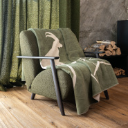 Green mountain throw blanket with a beige ibex pattern.