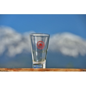 Red Edelweiss flowers on orange juice glass